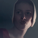 A handmaid shows June why she’s unable to speak.